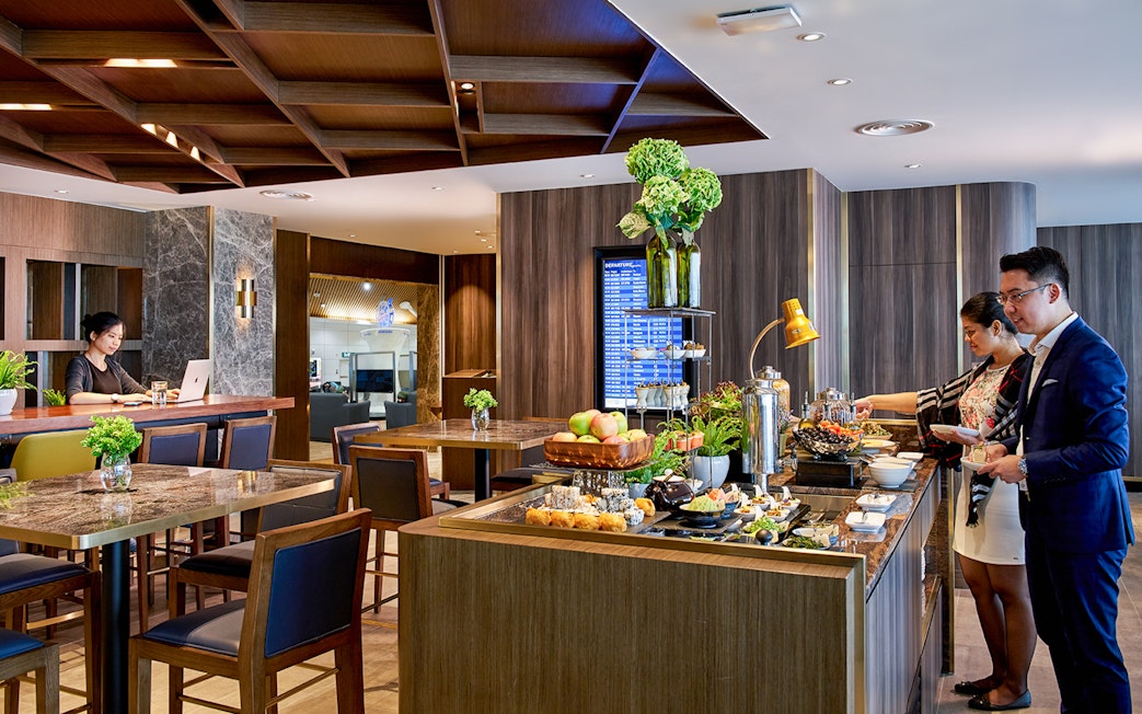 Plaza Premium Lounge buffet area at Langkawi International Airport with guests dining.