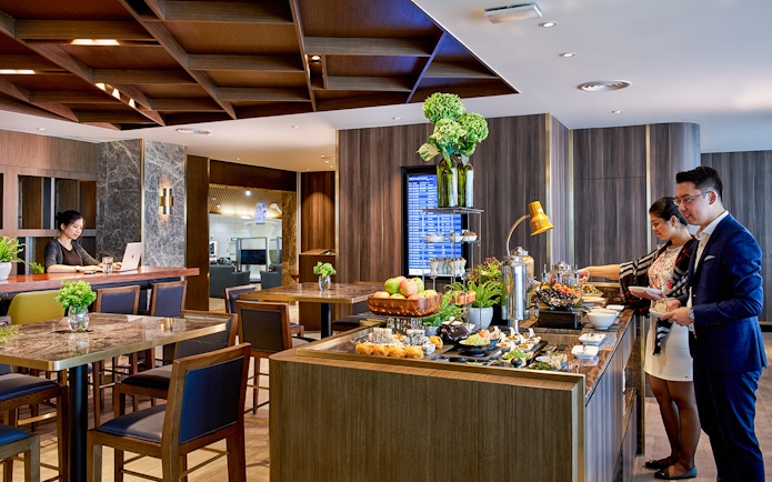Plaza Premium Lounge buffet area at Langkawi International Airport with guests dining.