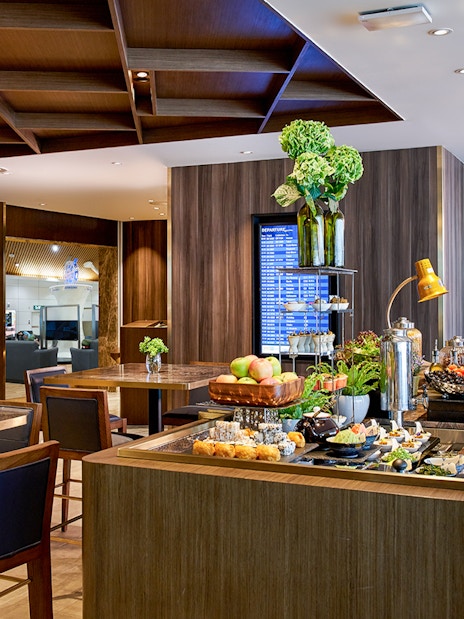 Plaza Premium Lounge buffet area at Langkawi International Airport with guests dining.