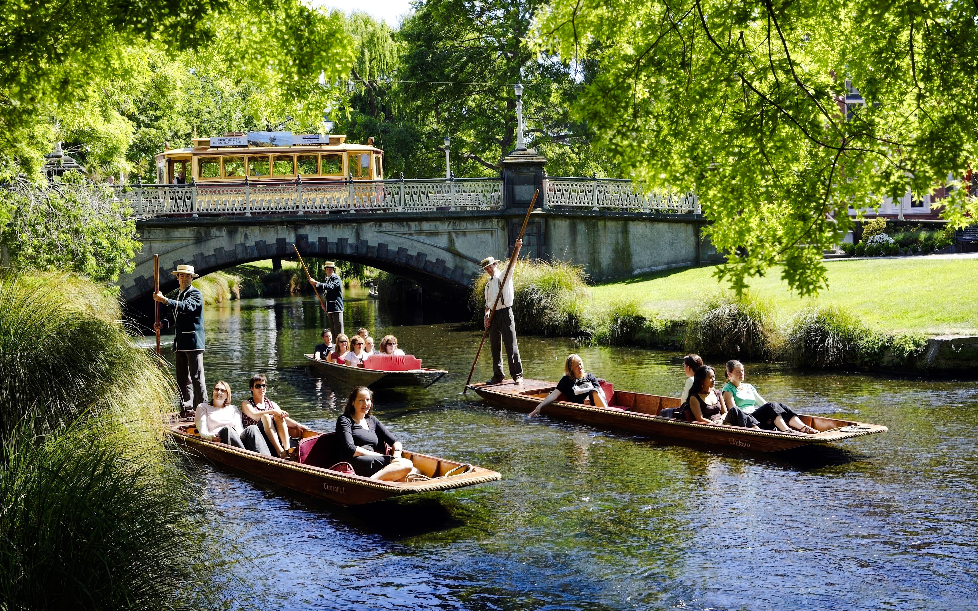 Punting ride on Avon River with people enjoying the view, Christchurch.