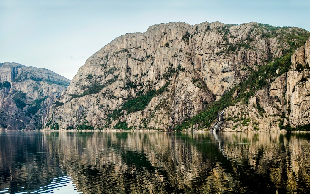 Lysefjord cliffs and waterfall viewed from a cruise, Stavanger, Norway.