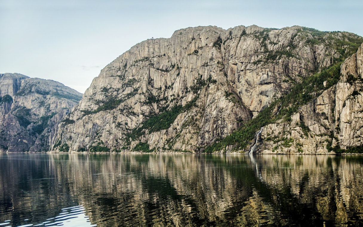 Lysefjord cliffs and waterfall viewed from a cruise, Stavanger, Norway.