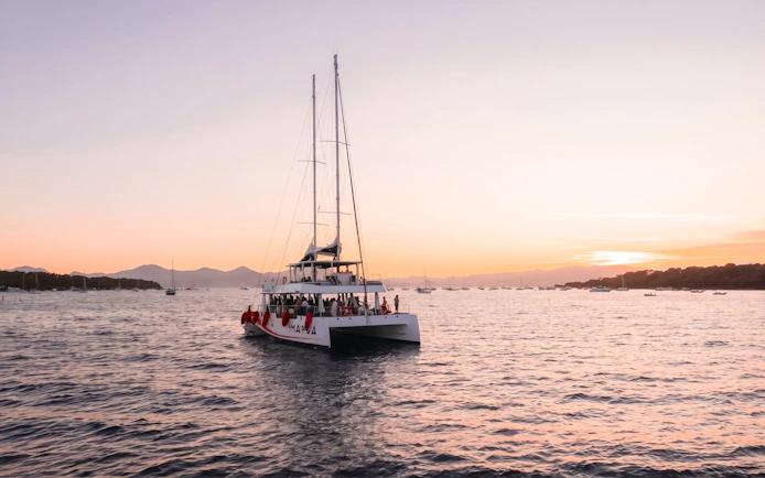 Catamaran sailing at sunset in French Riviera.