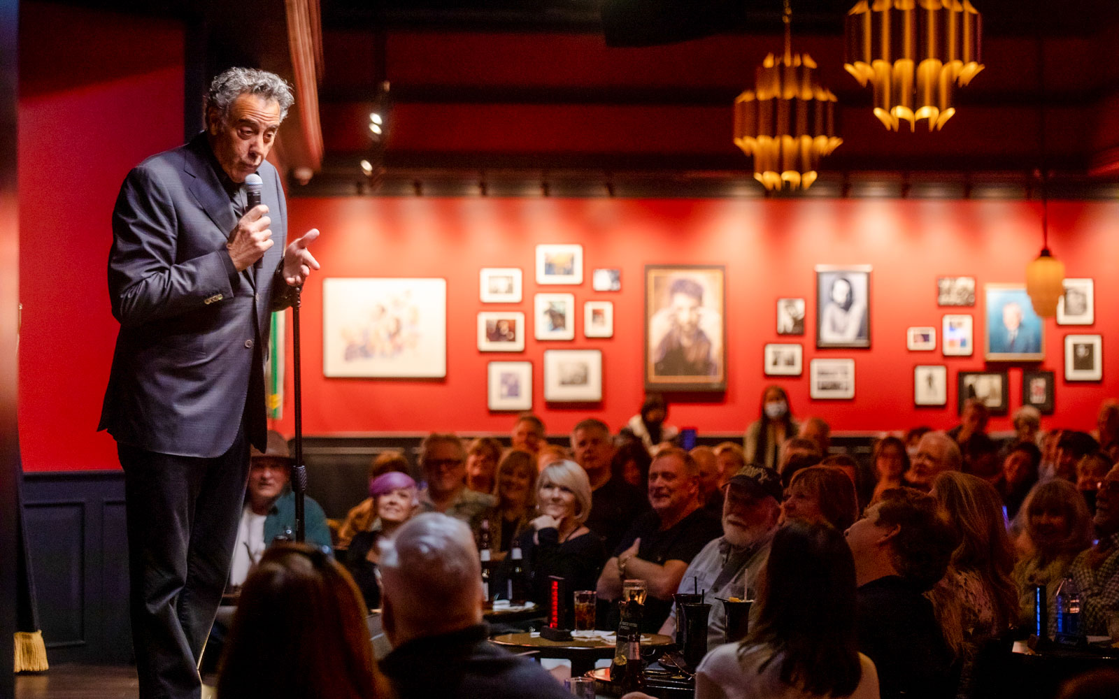 Comedian performing on stage at Brad Garrett's Comedy Club in Las Vegas.