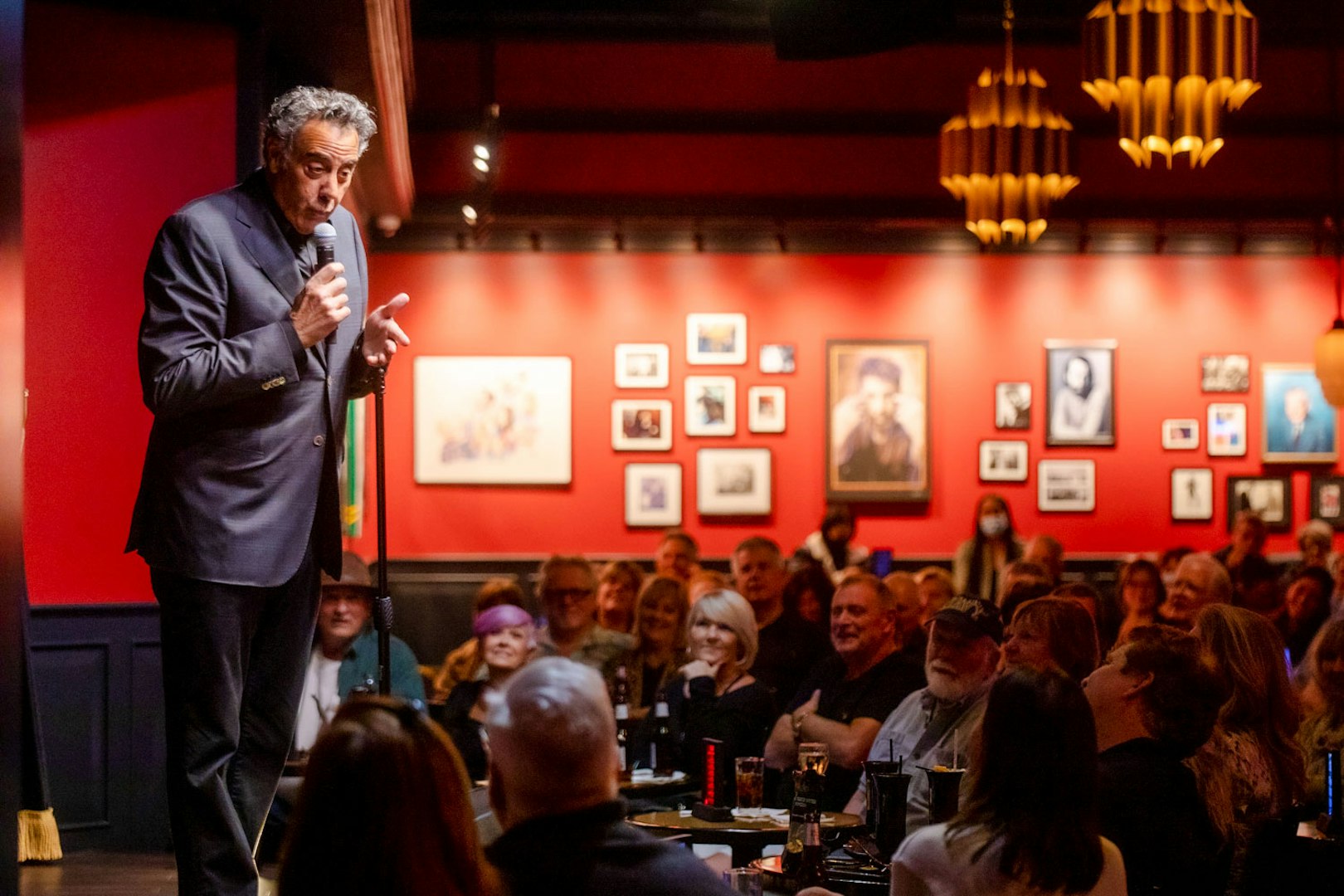 Comedian performing on stage at Brad Garrett's Comedy Club in Las Vegas.