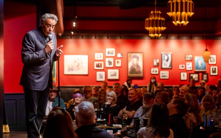 Comedian performing on stage at Brad Garrett's Comedy Club in Las Vegas.