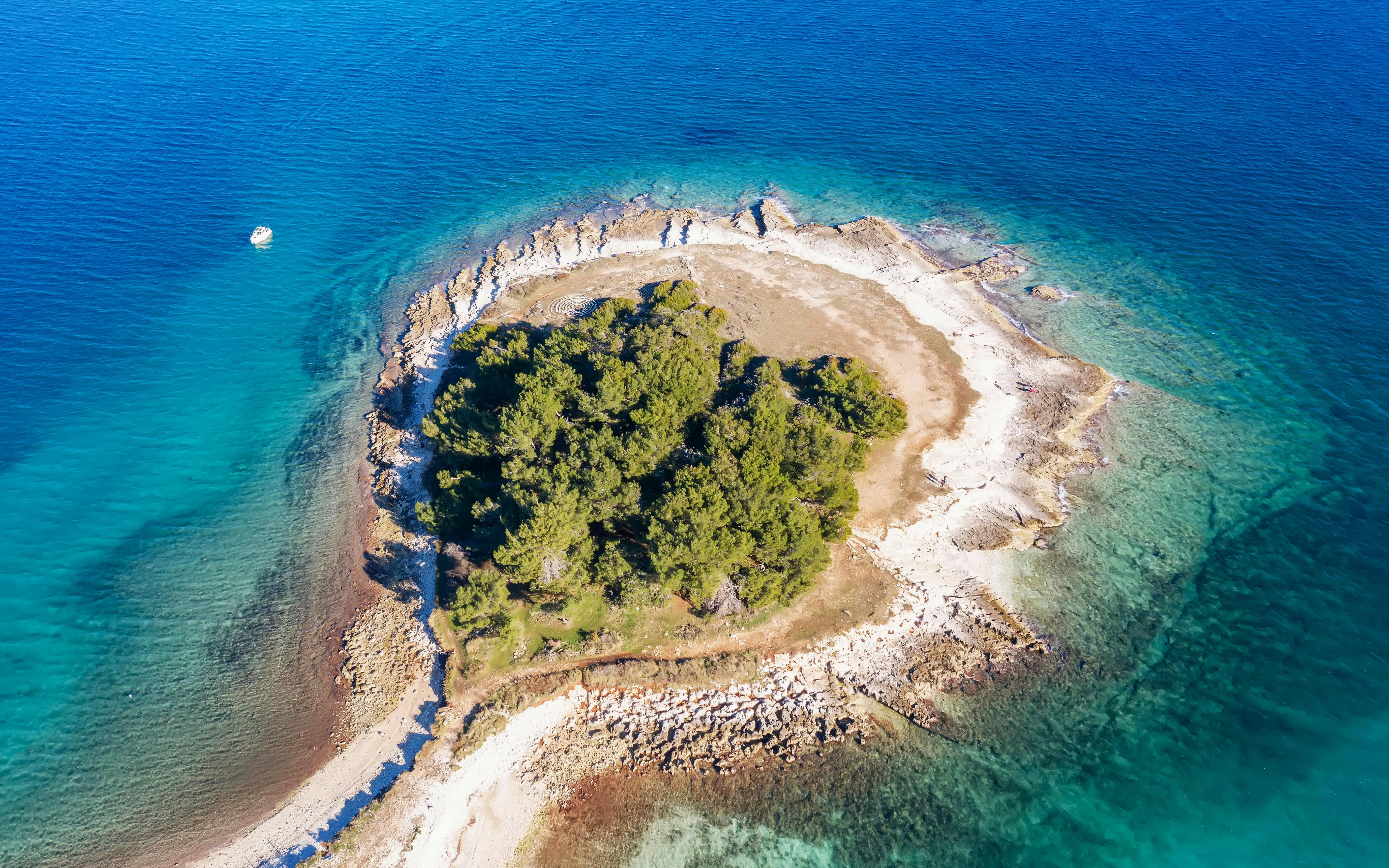 Aerial view of Cape Kamenjak peninsula with clear blue waters, Premantura, Istria, Croatia.