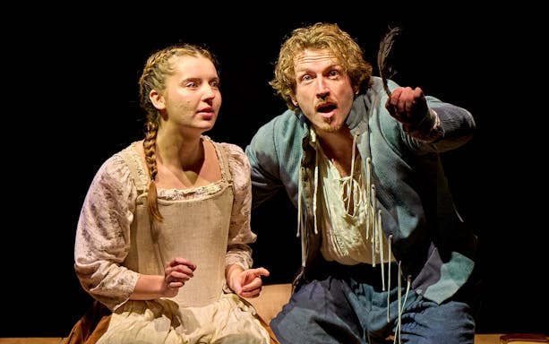 Actors performing a scene from "Hamnet" on stage.