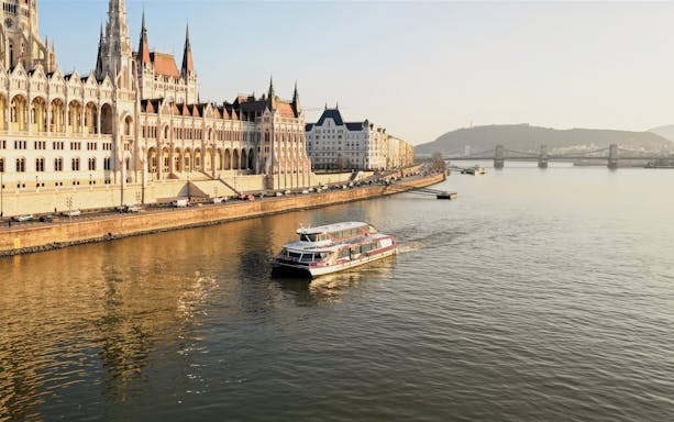 Sightseeing cruise on the Danube River passing Budapest Parliament building.