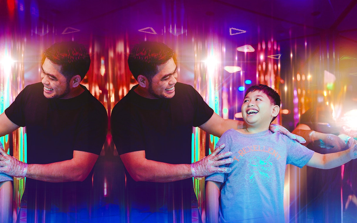 Tourists enjoying a colorful mirror maze experience.