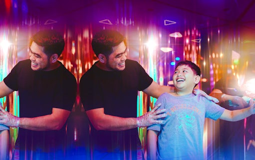 Tourists enjoying a colorful mirror maze experience.