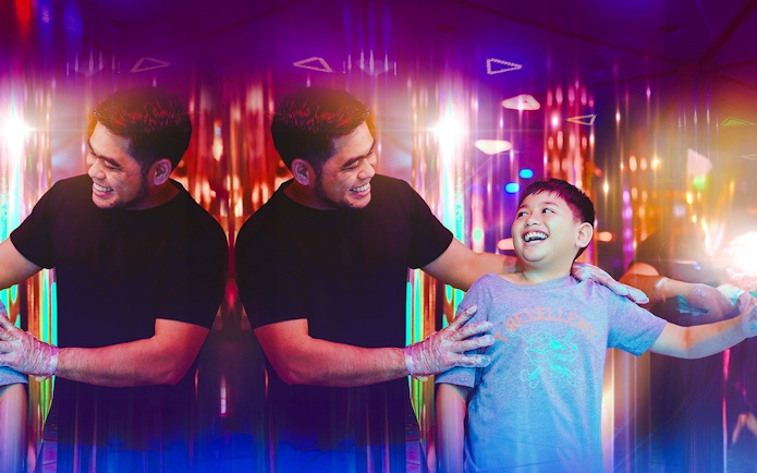 Tourists enjoying a colorful mirror maze experience.