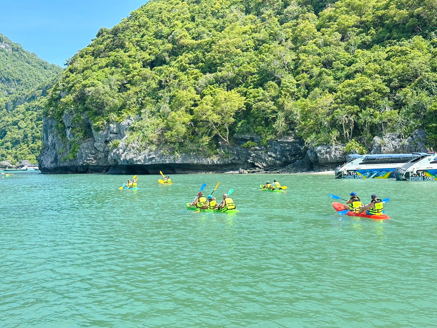 Kayakers exploring Anthong Marine Park's lush cliffs, Koh Samui.