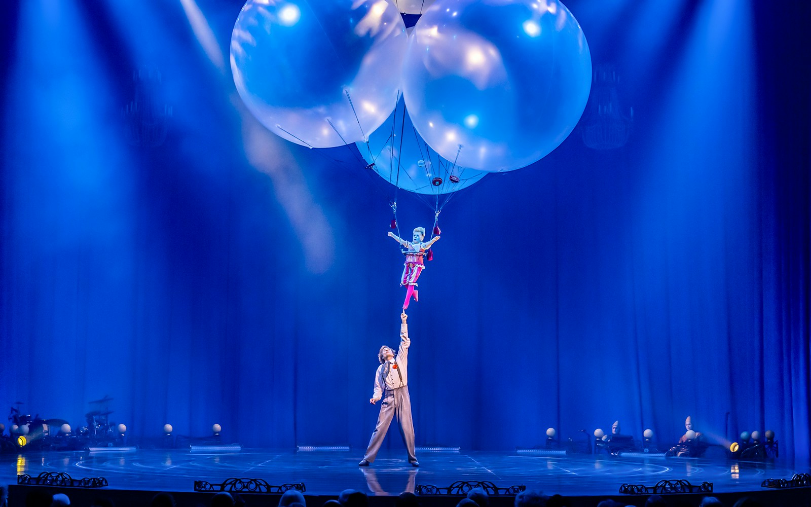 Performer suspended by balloons in Cirque du Soleil's Corteo show.