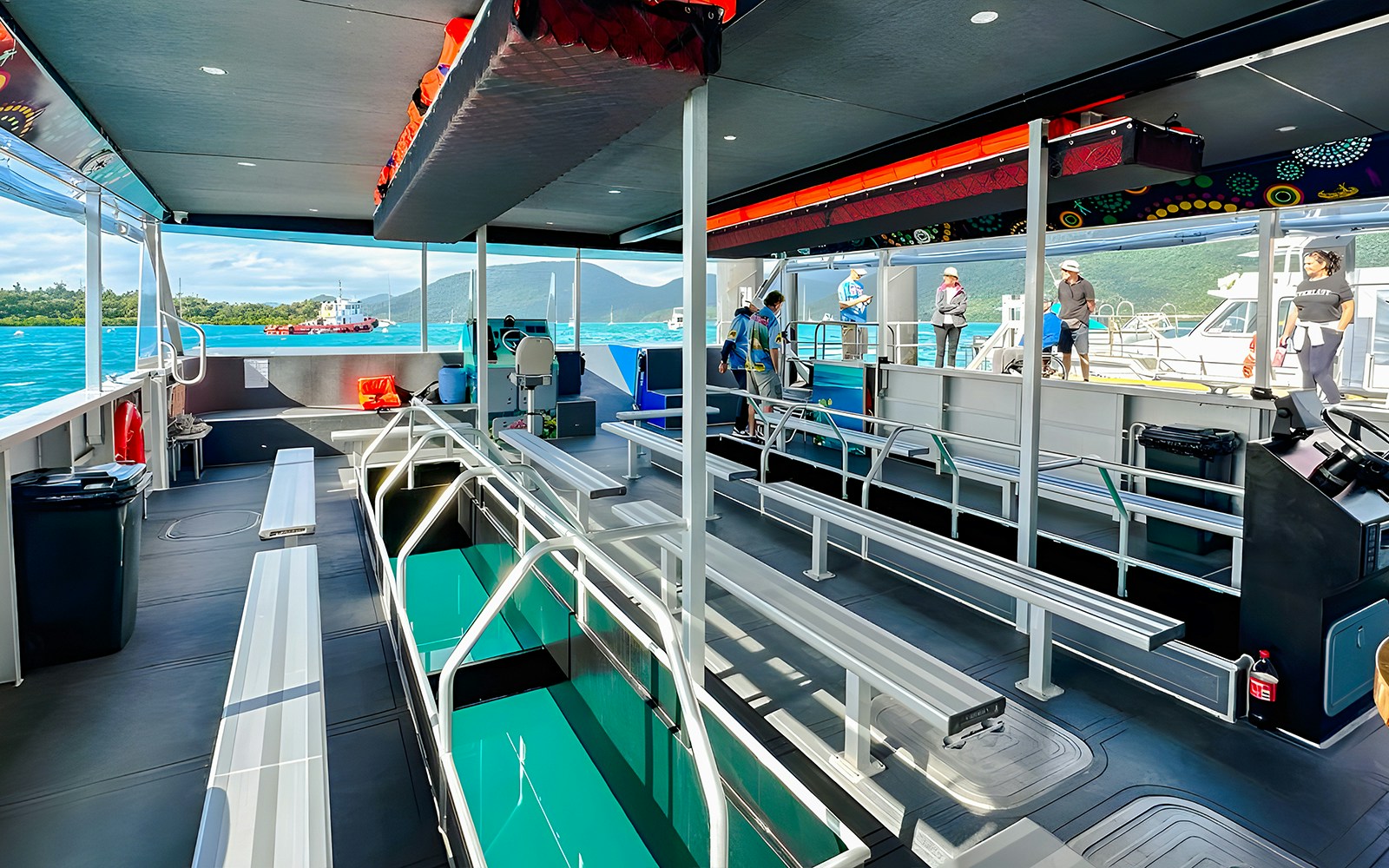 Glass bottom boat interior at Airlie Beach with passengers boarding.