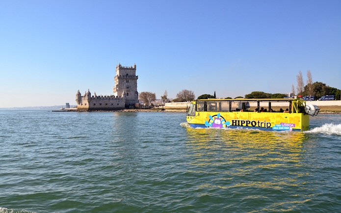 Amphibious tour bus near Belém Tower on Lisbon sightseeing guided tour.
