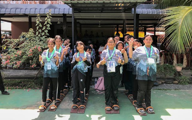 Visitors participating in a traditional group activity at Koisaan Cultural Village.