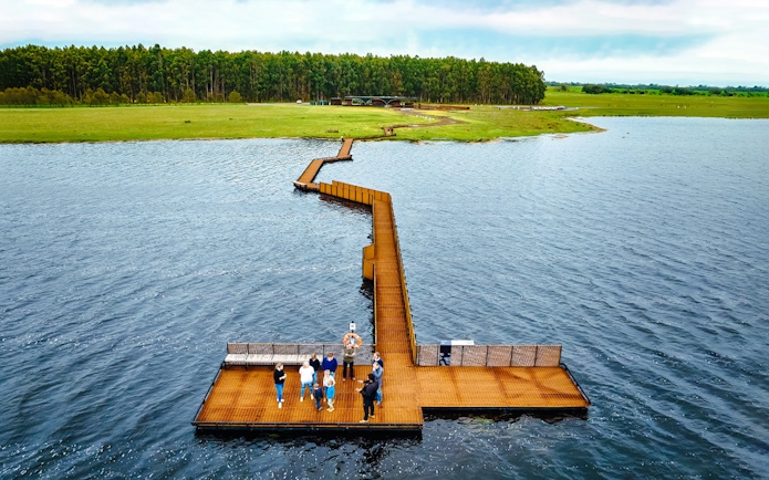 Floating boardwalk on Tae Rak with group on guided cultural walk.