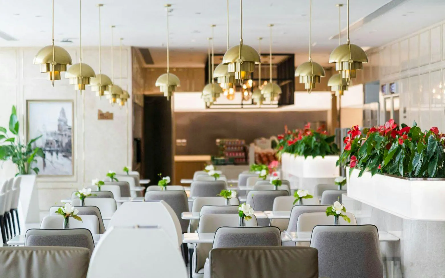 Dining area with modern lighting and floral decor at Shanghai Pudong International Airport Satellite Terminal 2.