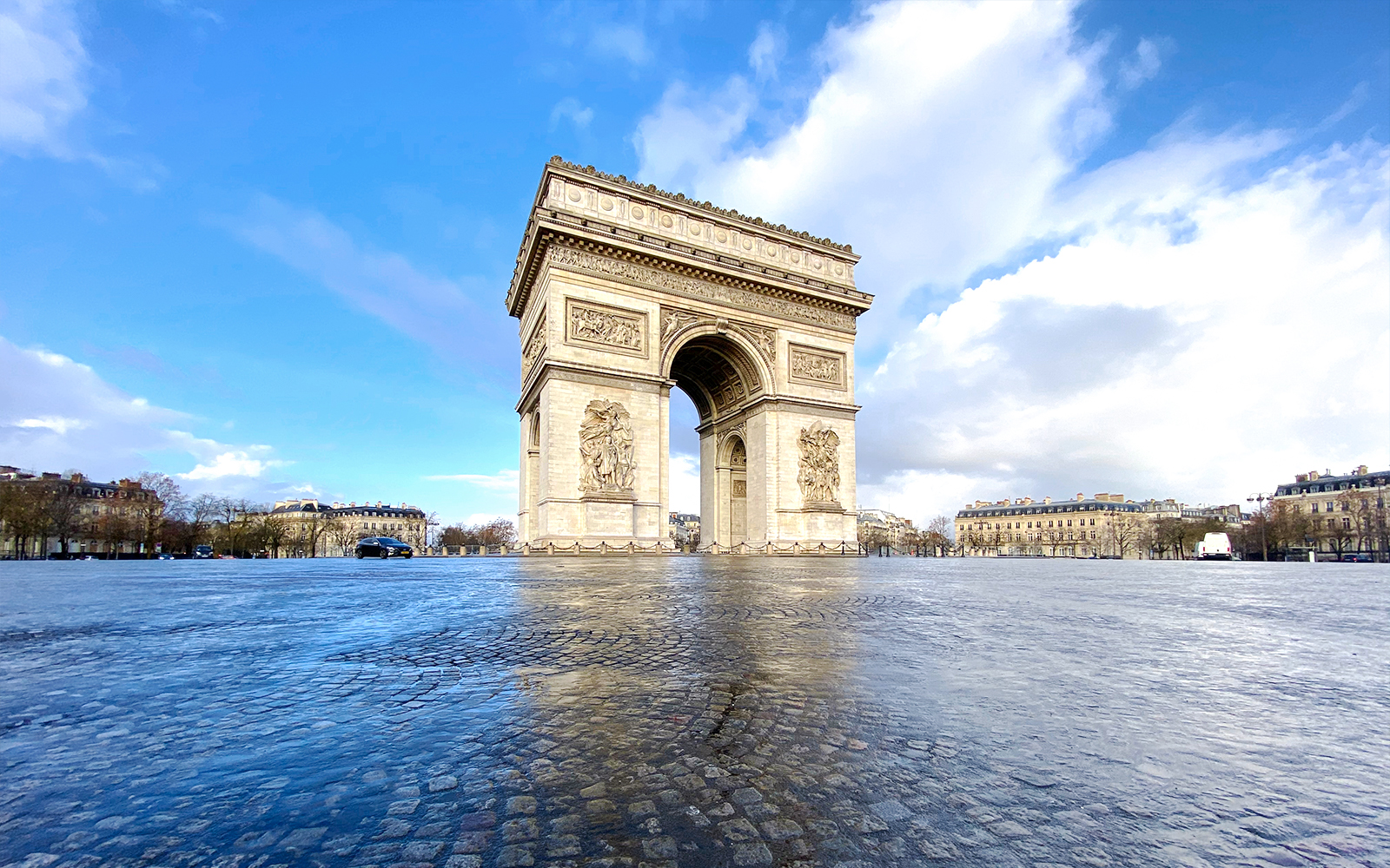 Arc de Triomphe rooftop view with Paris skyline in the background.