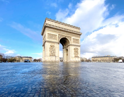 Arc de Triomphe rooftop view with Paris skyline in the background.