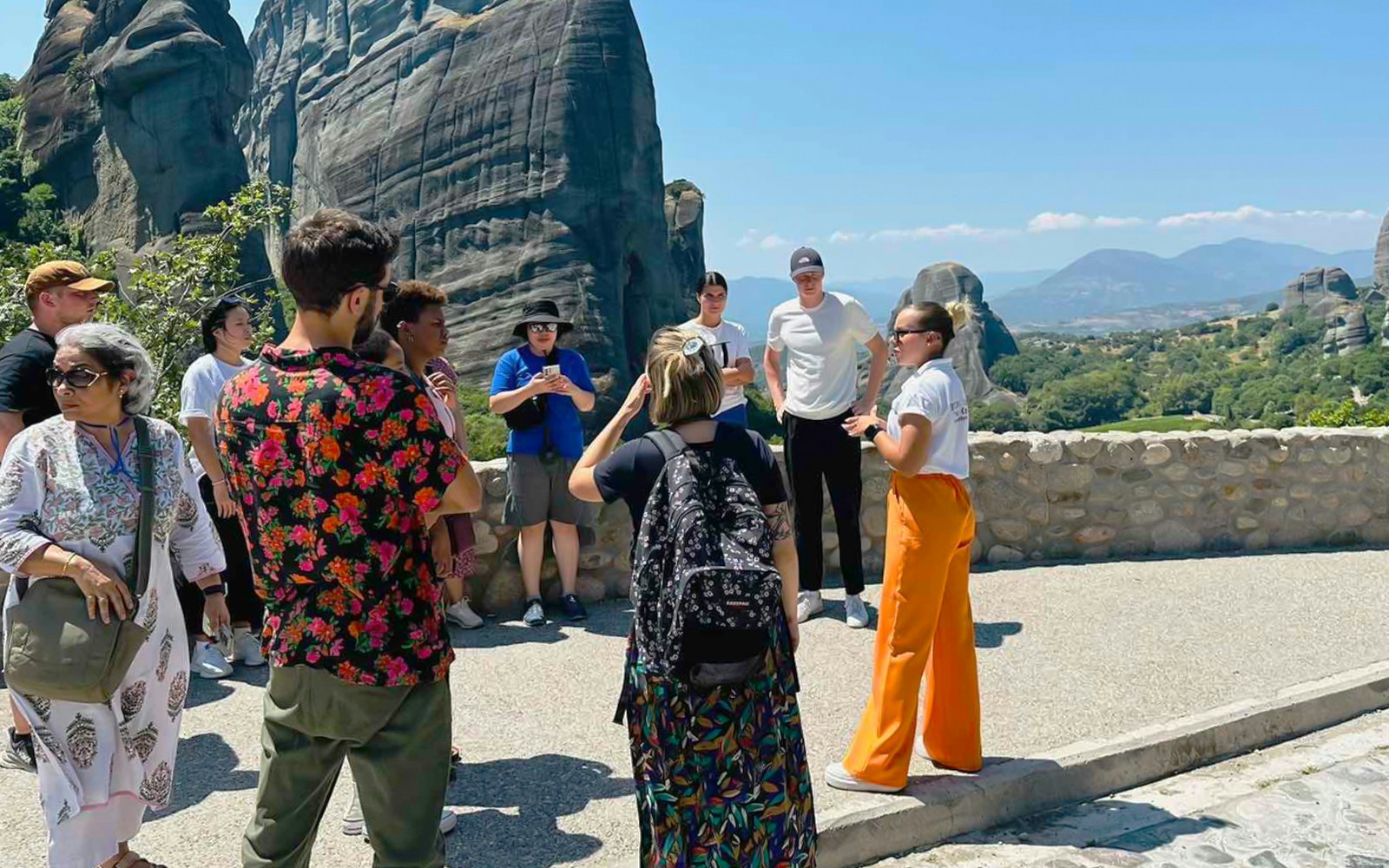 Tour group at Meteora rock formations during 1-day train trip from Athens.