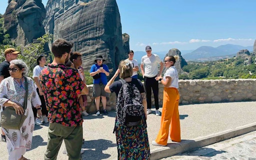 Tour group at Meteora rock formations during 1-day train trip from Athens.