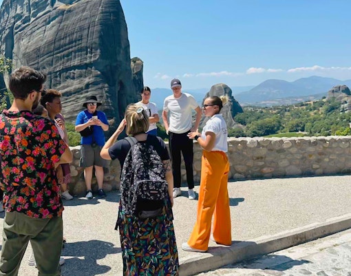 Tour group at Meteora rock formations during 1-day train trip from Athens.