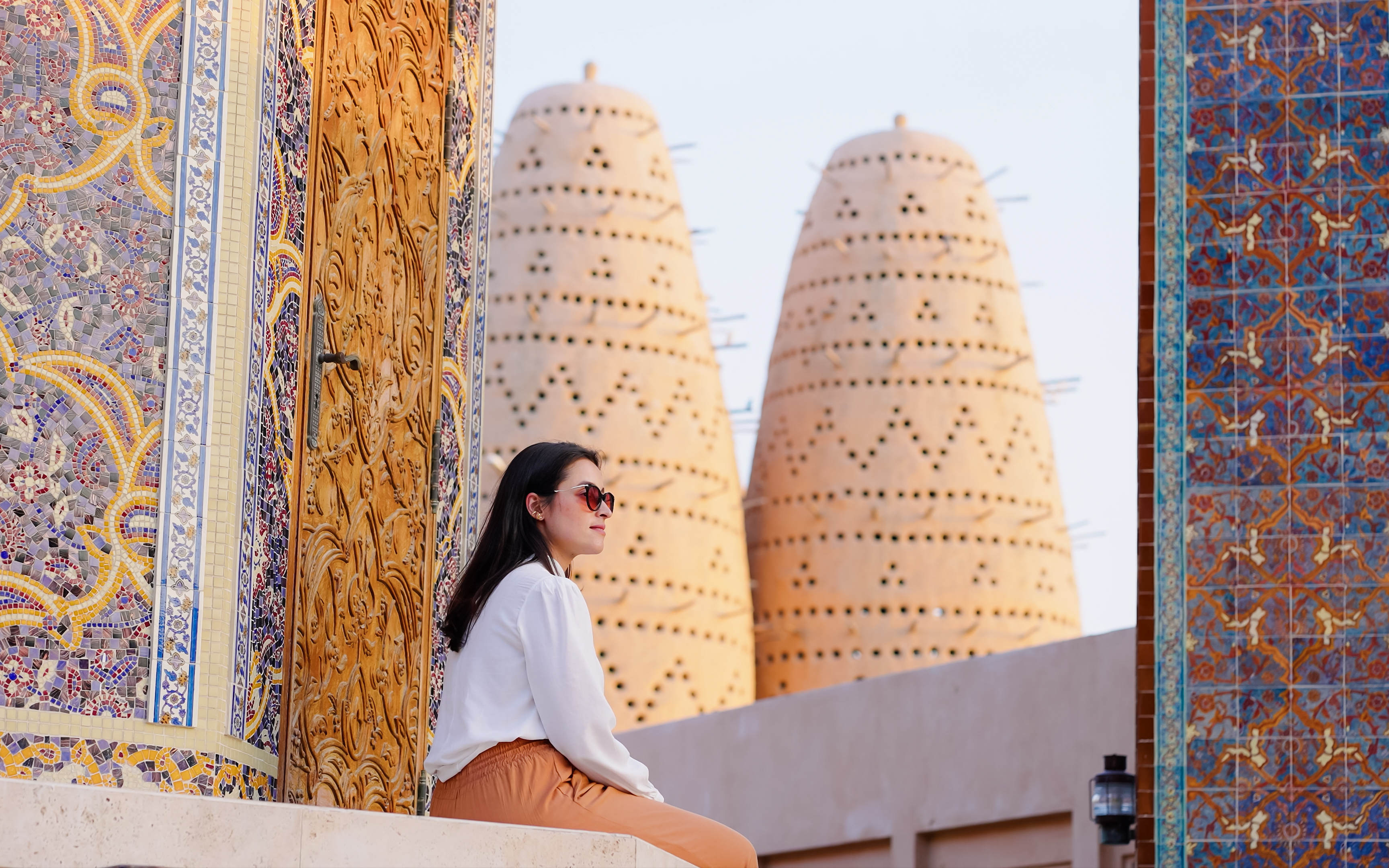 Woman at Blue mosque of Katara village made of colorful mosaic in Doha Qatar