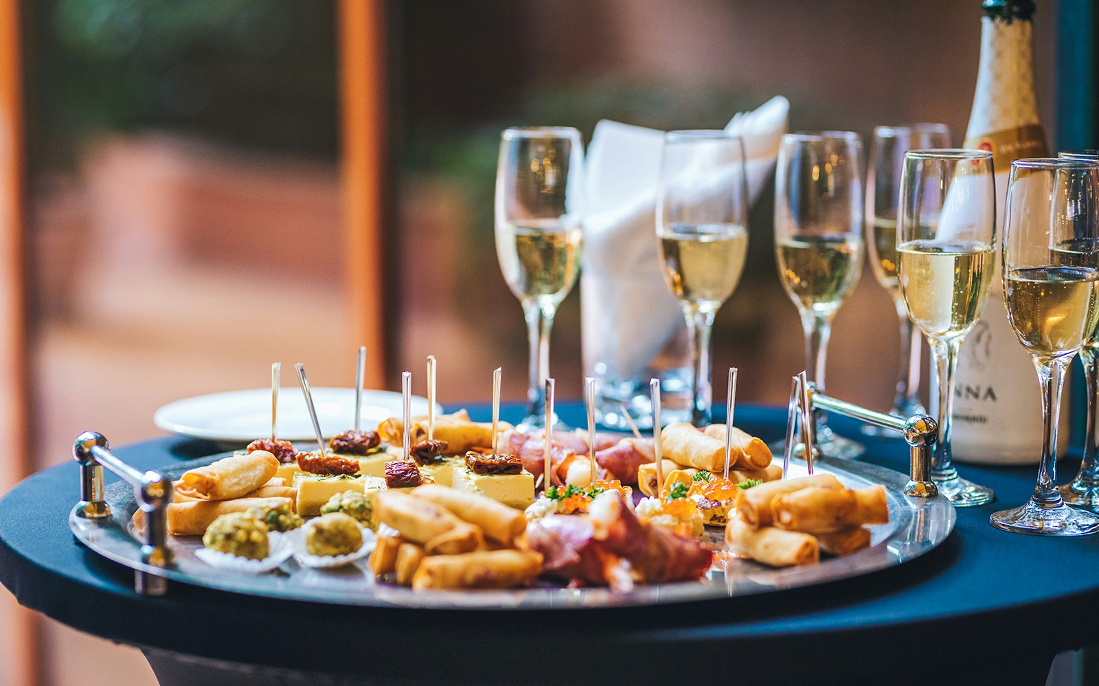 Canapes and champagne on a table during Sydney New Year's Eve dinner cruise.