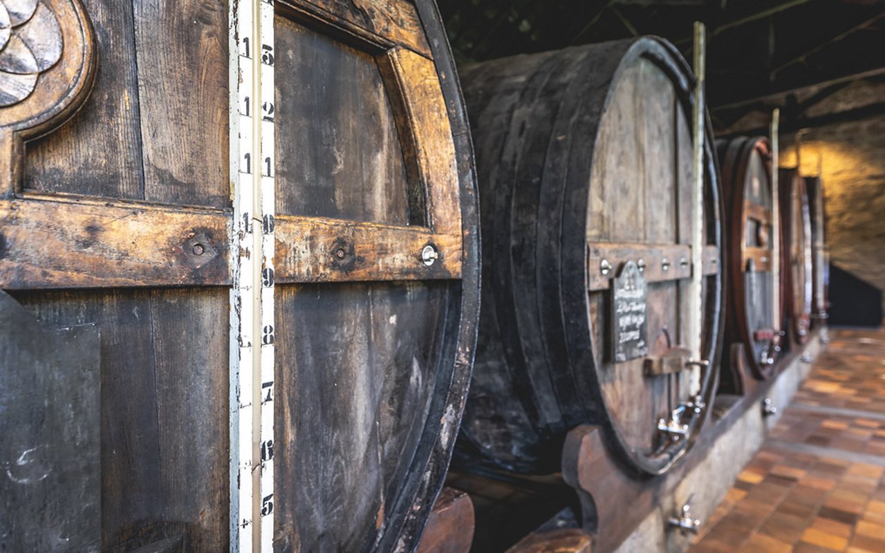 Wooden wine barrels in a Porto cellar.