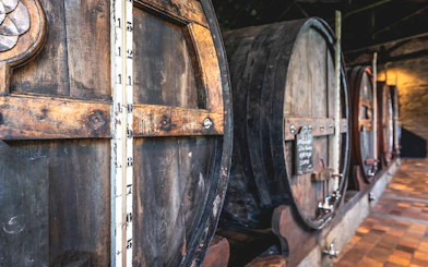 Wooden wine barrels in a Porto cellar.