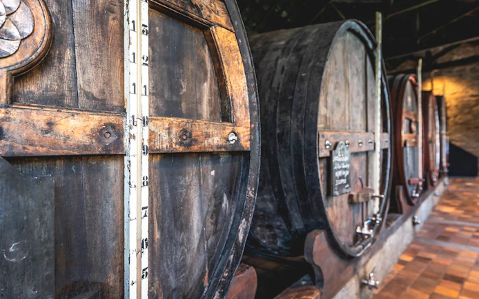 Wooden wine barrels in a Porto cellar.
