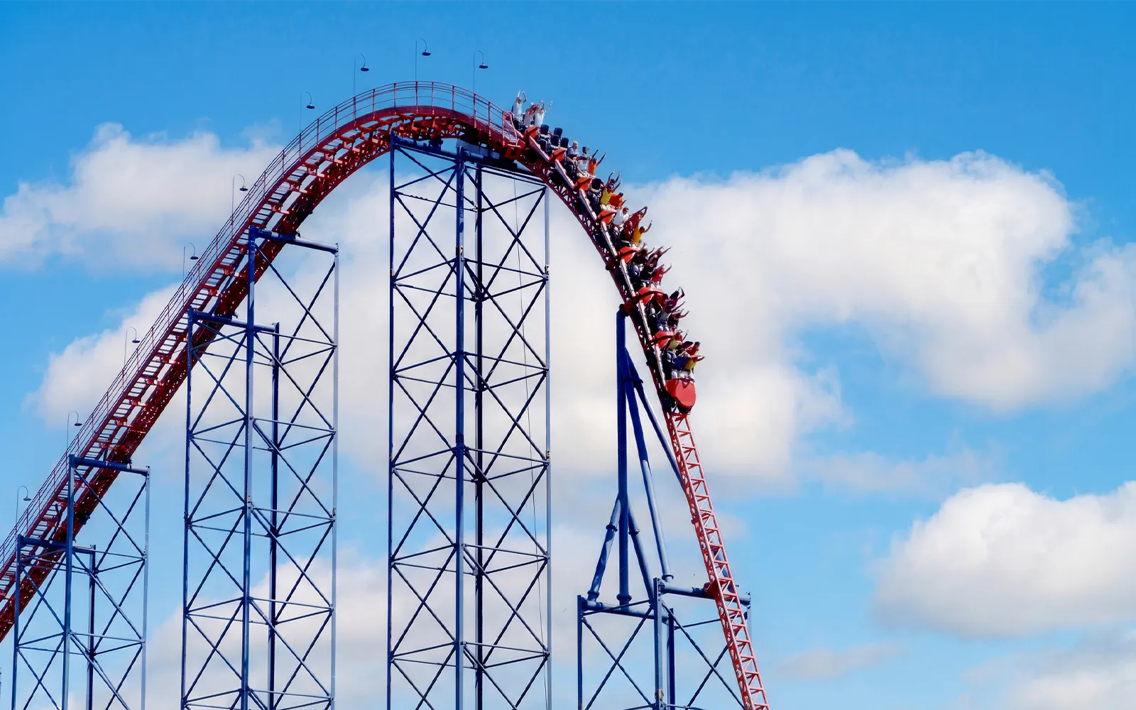 Roller coaster Ride of Steel at Six Flags Darien Lake with riders descending steep drop.