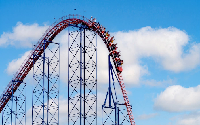 Roller coaster Ride of Steel at Six Flags Darien Lake with riders descending steep drop.