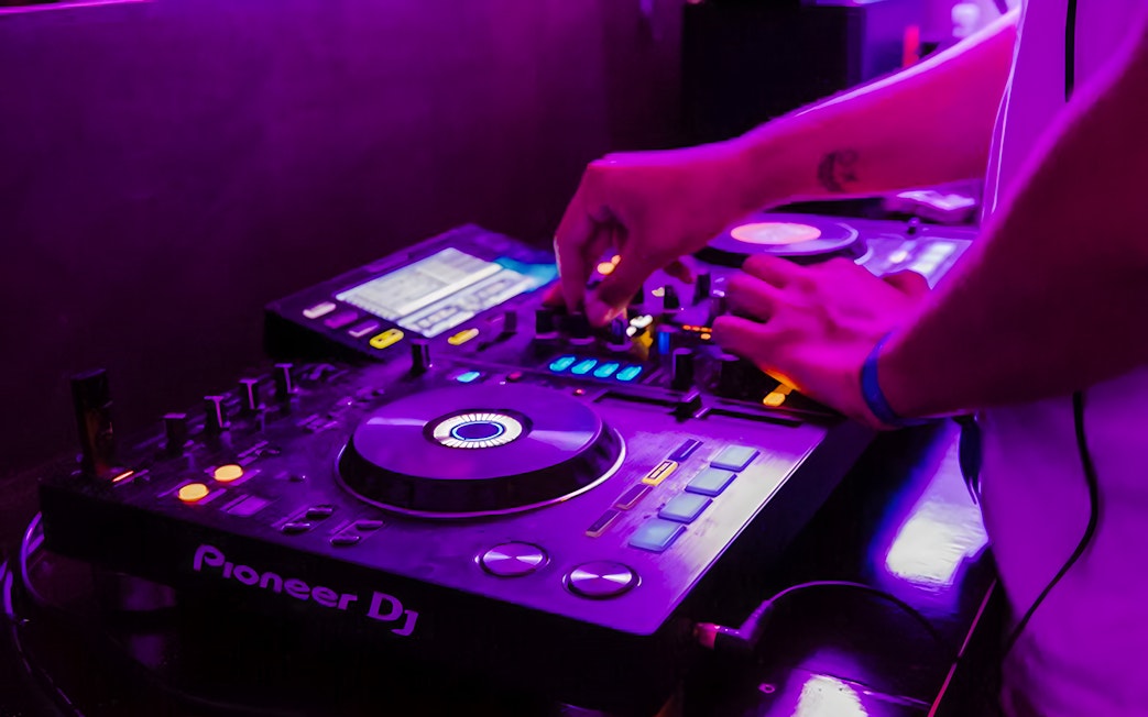 DJ mixing music on a boat crawl in Split.