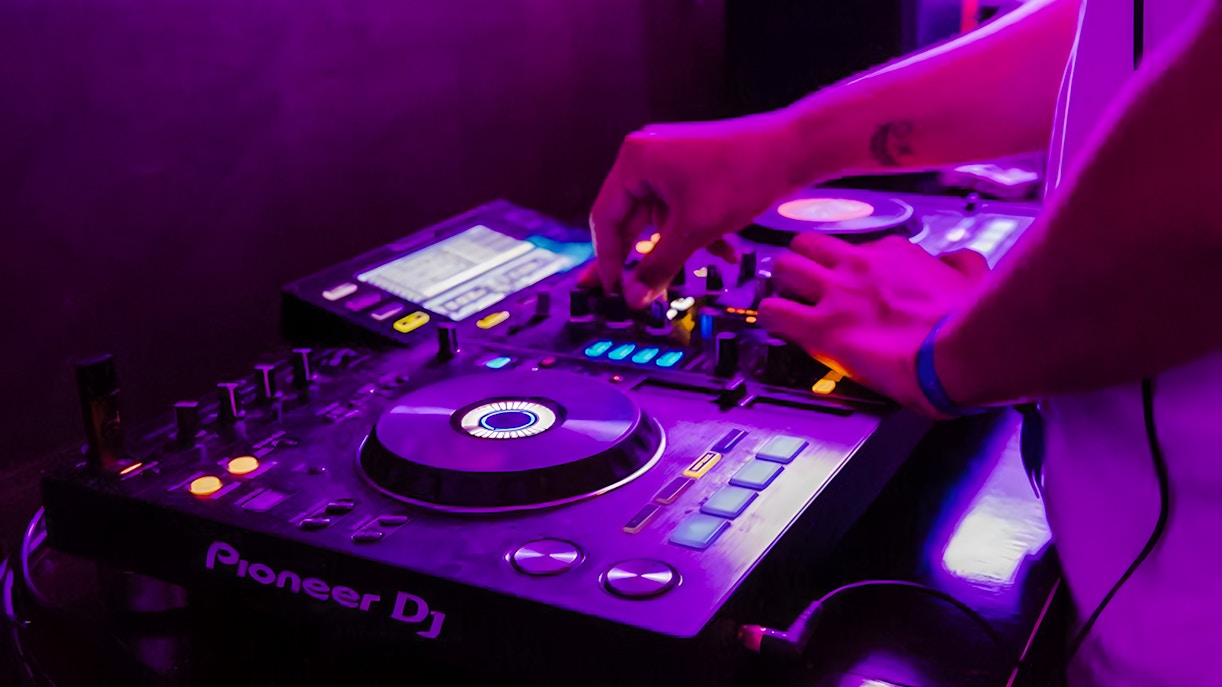 DJ mixing music on a boat crawl in Split.