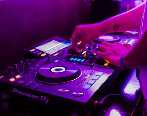 DJ mixing music on a boat crawl in Split.