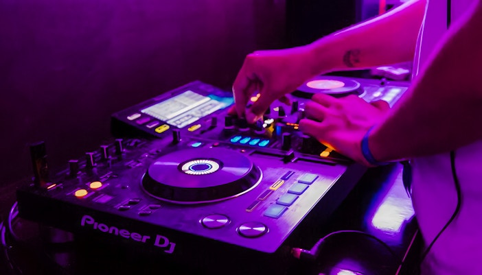 DJ mixing music on a boat crawl in Split.