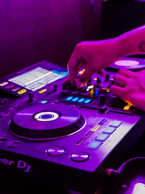 DJ mixing music on a boat crawl in Split.