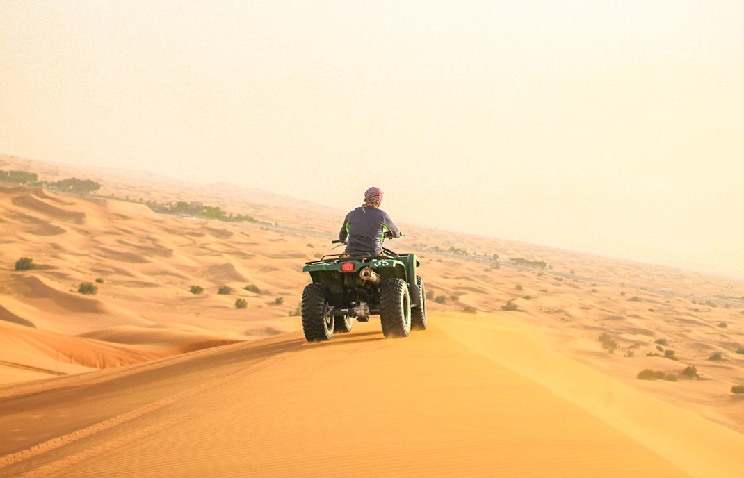 A guest Quadbiking on a dune