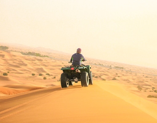 A guest Quadbiking on a dune
