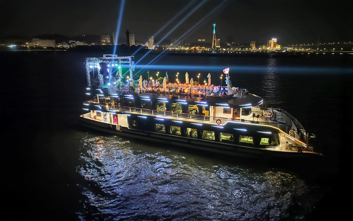 Luxury cruise ship illuminated at night in Ha Long Bay, Vietnam.