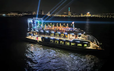 Luxury cruise ship illuminated at night in Ha Long Bay, Vietnam.
