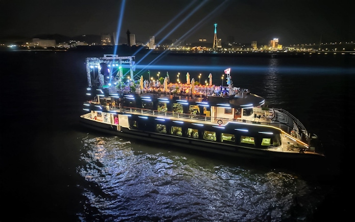Luxury cruise ship illuminated at night in Ha Long Bay, Vietnam.