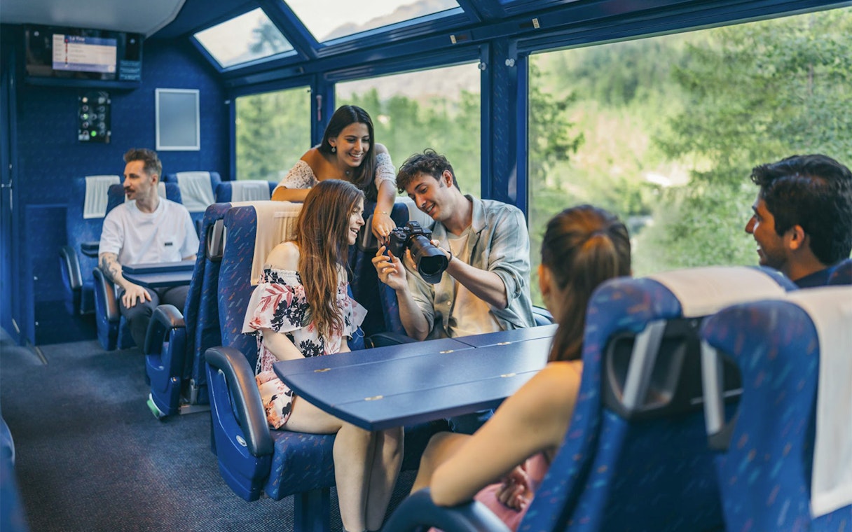 Group enjoying scenic train ride with Interrail Global Mobile Pass Flex.