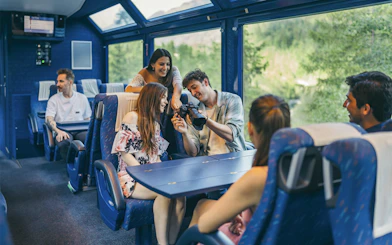 Group enjoying scenic train ride with Interrail Global Mobile Pass Flex.