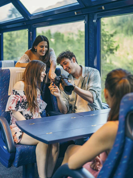 Group enjoying scenic train ride with Interrail Global Mobile Pass Flex.