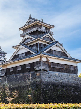 Kumamoto Castle with traditional Japanese architecture and stone walls in Kumamoto, Japan.