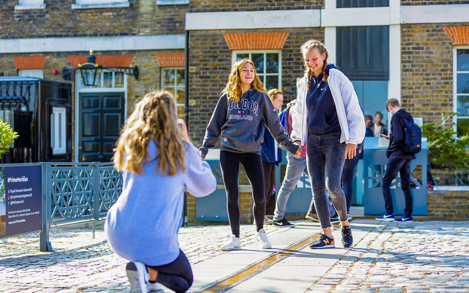 Guests standing on the Prime Meridian line at Royal Observatory Greenwich.